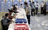 Illustrative: People line up to vote in the presidential election at a polling station in Tehran, Iran, Friday, June 18, 2021. (AP Photo/Ebrahim Noroozi)