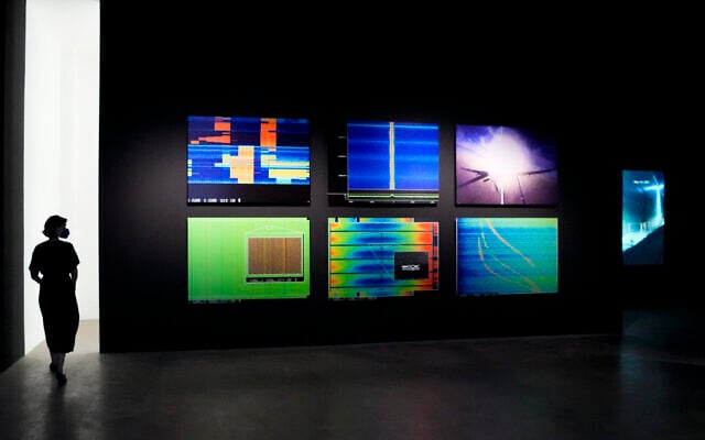 A woman walks through an exhibition by American artist and filmmaker Laura Poitras, near the art work 'Anarchist' by Poitras in collaboration with Henrik Moltke, at the N.K.B. gallery in Berlin, Germany, on June 18, 2021. (AP Photo/Markus Schreiber) A woman walks through an exhibition by American artist and filmmaker Laura Poitras, near the art work 'Anarchist' by Poitras in collaboration with Henrik Moltke, at the N.K.B. gallery in Berlin, Germany, on June 18, 2021. (AP Photo/Markus Schreiber)