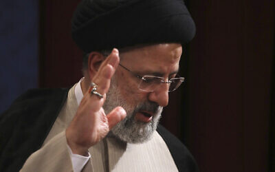 Iran's new President-elect Ebrahim Raisi waves at the conclusion of his news conference in Tehran, Iran, June 21, 2021. (Vahid Salemi/AP)