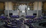 German Chancellor Angela Merkel delivers a speech during a plenary session at the Bundestag in Berlin, Germany, June 24, 2021. (AP Photo/Markus Schreiber)