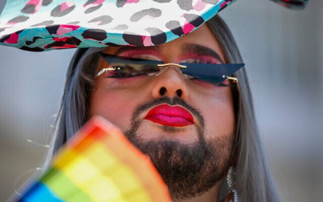 A participant pauses in the annual Pride Parade, in Tel Aviv, Israel, Friday, June 25, 2021. (AP Photo/Ariel Schalit) A participant pauses in the annual Pride Parade, in Tel Aviv, Israel, Friday, June 25, 2021. (AP Photo/Ariel Schalit)