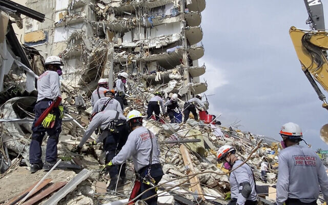 This photo provided by Miami-Dade Fire Rescue, search and rescue personnel search for survivors through the rubble at the Champlain Towers South Condo in Surfside, Florida, section of Miami, June 25, 2021. (Miami-Dade Fire Rescue via AP) This photo provided by Miami-Dade Fire Rescue, search and rescue personnel search for survivors through the rubble at the Champlain Towers South Condo in Surfside, Florida, section of Miami, June 25, 2021. (Miami-Dade Fire Rescue via AP)
