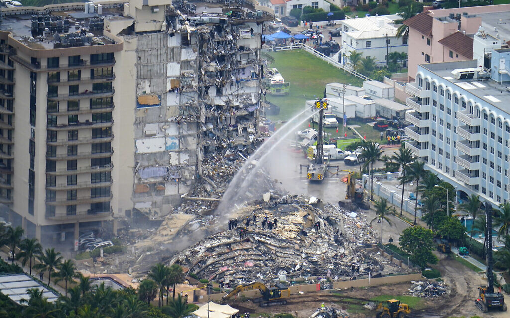 Rescue personnel work at the remains of the Champlain Towers South Condo in Surfside, Florida, on June 25, 2021 (AP Photo/Gerald Herbert)