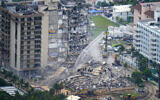 Rescue personnel work at the remains of the Champlain Towers South Condo in Surfside, Florida, on June 25, 2021. (AP Photo/Gerald Herbert)
