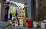 Flowers and candles laid at the scene of a deadly stabbing in central Wuerzburg, Germany, June 26, 2021. (Michael Probst/AP)