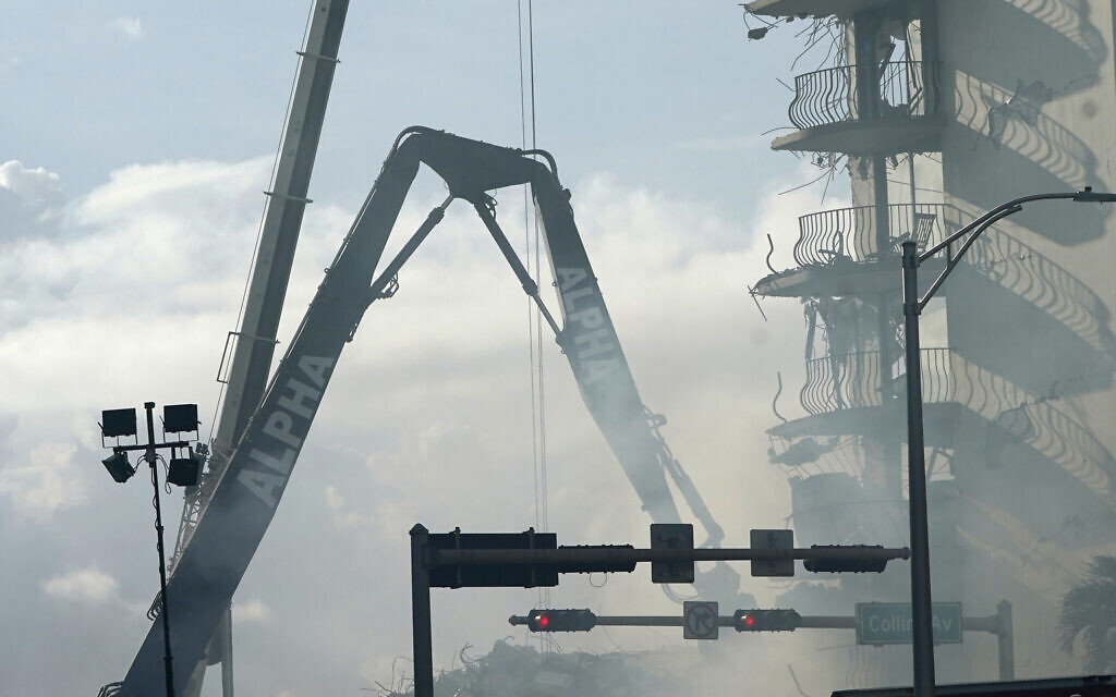 A crane works at the site of the Champlain Towers South Condo building,  on June 26, 2021, in the Surfside area of Miami. (AP Photo/Lynne Sladky)