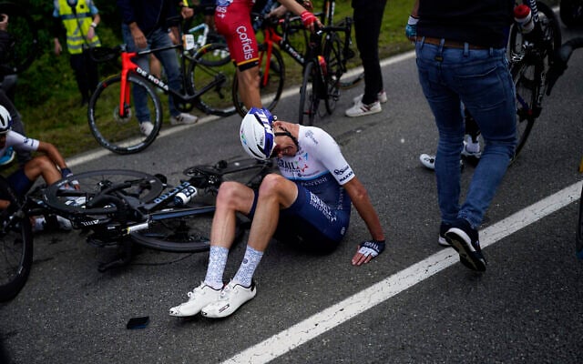 Chris Froome lays on the road after crashing during the first stage of the Tour de France, on June 26, 2021. (AP Photo/Daniel Cole) Chris Froome lays on the road after crashing during the first stage of the Tour de France, on June 26, 2021. (AP Photo/Daniel Cole)