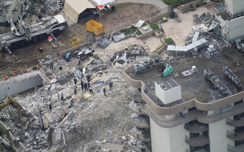 Workers search in the rubble at the Champlain Towers South Condo, in Surfside, Florida, on June 26, 2021. (AP Photo/Gerald Herbert)