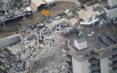 Workers search in the rubble at the Champlain Towers South Condo, in Surfside, Florida, on June 26, 2021. (AP Photo/Gerald Herbert)