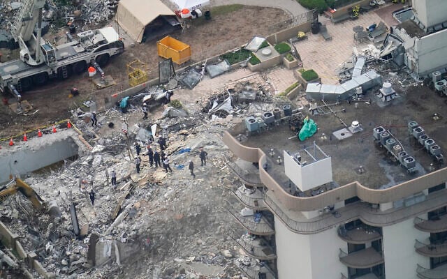 Workers search in the rubble at the Champlain Towers South Condo, in Surfside, Florida, on June 26, 2021. (AP Photo/Gerald Herbert) Workers search in the rubble at the Champlain Towers South Condo, in Surfside, Florida, on June 26, 2021. (AP Photo/Gerald Herbert)