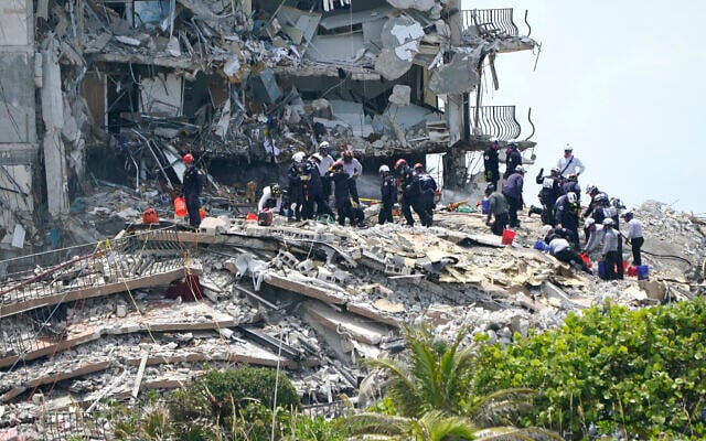 Rescue workers search in the rubble at the Champlain Towers South condominium, June 26, 2021, in the Surfside area of Miami (AP Photo/Lynne Sladky) Rescue workers search in the rubble at the Champlain Towers South condominium, June 26, 2021, in the Surfside area of Miami (AP Photo/Lynne Sladky)
