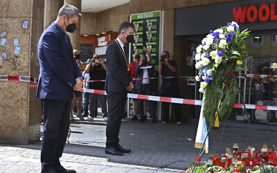 Bavaria's governor Markus Soeder, left, and the mayor of Wuerzburg, Christian Schuchardt, attend a memorial service for the victims of a brutal knife attack that left three women dead, in Wuerzburg, Germany, June 27, 2021. (Karl-Josef Hildenbrand/dpa via AP)