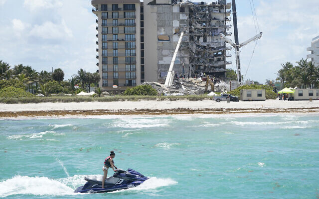A woman on a WaveRunner passes by the Champlain Towers South Condo, Sunday, June 27, 2021, in Surfside, Fla. Many people are still unaccounted for after Thursday's fatal collapse. (AP/Wilfredo Lee) A woman on a WaveRunner passes by the Champlain Towers South Condo, Sunday, June 27, 2021, in Surfside, Fla. Many people are still unaccounted for after Thursday's fatal collapse. (AP/Wilfredo Lee)
