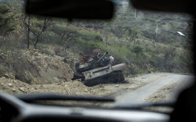 A destroyed tank sits by the side of a road leading to Abi Adi, in the Tigray region of northern Ethiopia in May 2021. (AP Photo/Ben Curtis)