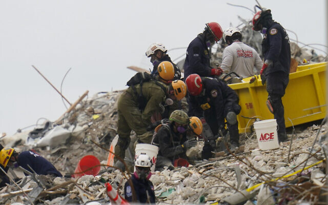 Crews work in the rubble of Champlain Towers South residential condo, on June 29, 2021, in Surfside, Florida. (AP Photo/Gerald Herbert) Crews work in the rubble of Champlain Towers South residential condo, on June 29, 2021, in Surfside, Florida. (AP Photo/Gerald Herbert)