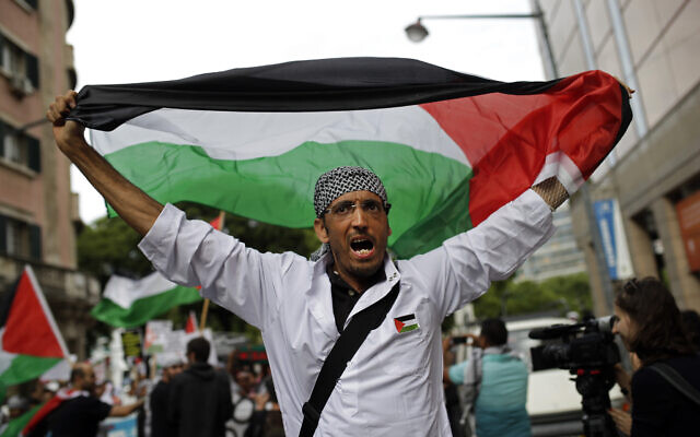 Illustrative: A man holding up a Palestinian flag shouts slogans during a protest against Israeli army strikes in the Gaza strip, Friday, Aug. 1, 2014, in Lisbon. (AP Photo/Francisco Seco) Illustrative: A man holding up a Palestinian flag shouts slogans during a protest against Israeli army strikes in the Gaza strip, Friday, Aug. 1, 2014, in Lisbon. (AP Photo/Francisco Seco)