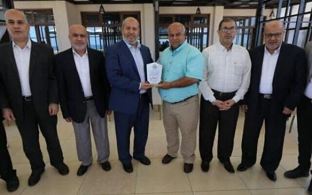 Hamas officials present Al Jazeera with a certificate after what the terror group called the outlet's 'high level of nationalism' in its coverage of last month's conflict with Israel, June 10, 2021 (via Twitter) Hamas officials present Al Jazeera with a certificate after what the terror group called the outlet's 'high level of nationalism' in its coverage of last month's conflict with Israel, June 10, 2021 (via Twitter)