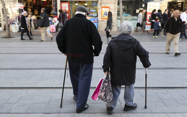 An elderly couple walking on Jaffa street in central Jerusalem on February 20, 2017. (Nati Shohat/Flash90)
