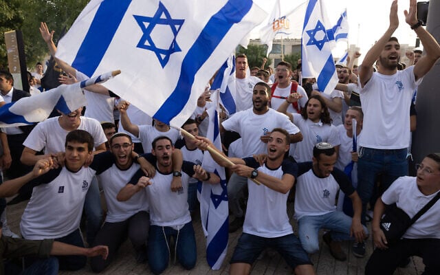 Israelis wave national flags during a Jerusalem Day march, in Jerusalem, May 10, 2021. (Nati Shohat/Flash90) Israelis wave national flags during a Jerusalem Day march, in Jerusalem, May 10, 2021. (Nati Shohat/Flash90)