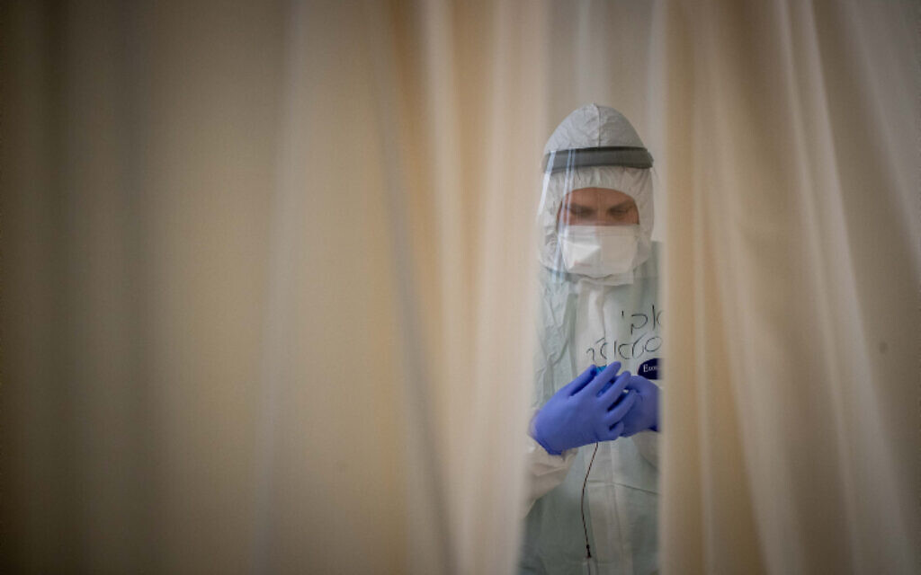 Illustrative image: A Shaare Zedek medical worker wearing safety gear as they work in a coronavirus ward on February 3, 2021 (Yonatan Sindel/Flash90) Illustrative image: A Shaare Zedek medical worker wearing safety gear as they work in a coronavirus ward on February 3, 2021 (Yonatan Sindel/Flash90)