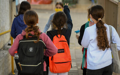 Illustrative: Israeli schoolkids wearing face masks return to school in Tel Aviv on February 11, 2021. (Avshalom Sassoni/Flash90)