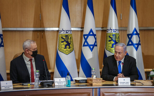 Prime Minister Benjamin Netanyahu and Alternate Prime Minister and Minister of Defense Benny Gantz at the weekly cabinet meeting, at the Jerusalem City Hall in Jerusalem on May 9, 2021. (Amit Shabi/POOL) Prime Minister Benjamin Netanyahu and Alternate Prime Minister and Minister of Defense Benny Gantz at the weekly cabinet meeting, at the Jerusalem City Hall in Jerusalem on May 9, 2021. (Amit Shabi/POOL)