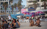 Israelis enjoy the beach in Tel Aviv on May 22, 2021. (Miriam Alster/FLASH90)