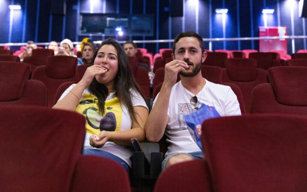 Delighted that cinemas have reopened, Israelis watch a movie in Jerusalem, May 27, 2021. (Olivier Fitoussi/Flash90)