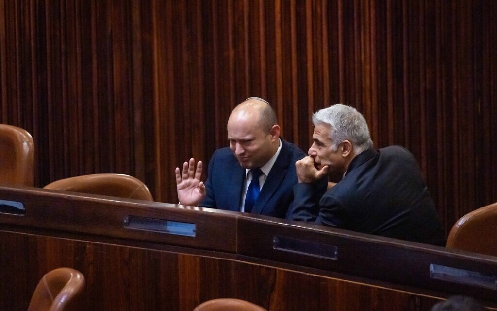 Yamina party leader Naftali Bennett, left, and Yash Atid leader Yair Lapid in the Knesset during the presidential election, June 2, 2021. (Olivier Fitoussi/Flash90) Yamina party leader Naftali Bennett, left, and Yash Atid leader Yair Lapid in the Knesset during the presidential election, June 2, 2021. (Olivier Fitoussi/Flash90)