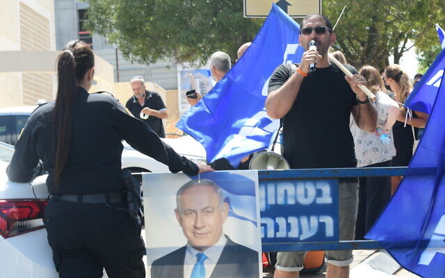 A man uses a microphone in a demonstration outside the home of Yamina party leader Naftali Bennett, at the time still in negotiations to form a government, in Ra'anana, on June 4, 2021. ( Avshalom Sassoni/Flash90) A man uses a microphone in a demonstration outside the home of Yamina party leader Naftali Bennett, at the time still in negotiations to form a government, in Ra'anana, on June 4, 2021. ( Avshalom Sassoni/Flash90)