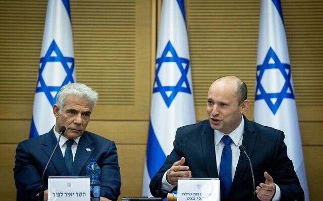 Israeli Prime Minister Naftali Bennett and Israeli Foreign minister Yair Lapid attend the first government conference, at the Israeli parliament on June 13, 2021. (Photo by Yonatan Sindel/Flash90)