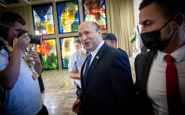 Prime Minister Naftali Bennett arrives for a group photo of the new government, at the president's residence in Jerusalem on June 14, 2021. (Yonatan Sindel/FLASH90)
