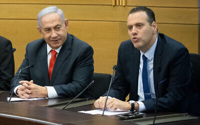 Prime Minister Benjamin Netanyahu (L) and Likud MK Miki Zohar at a meeting of opposition parties in Netanyahu's right wing-religious bloc, at the Knesset in Jerusalem, on June 14, 2021. (Yonatan Sindel/Flash90)
