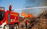 Firefighters try to extinguish a blaze in southern Israel that was sparked by a ballon-borne incendiary device launched by Palestinians in the Gaza Strip, June 15, 2021. (Flash90)