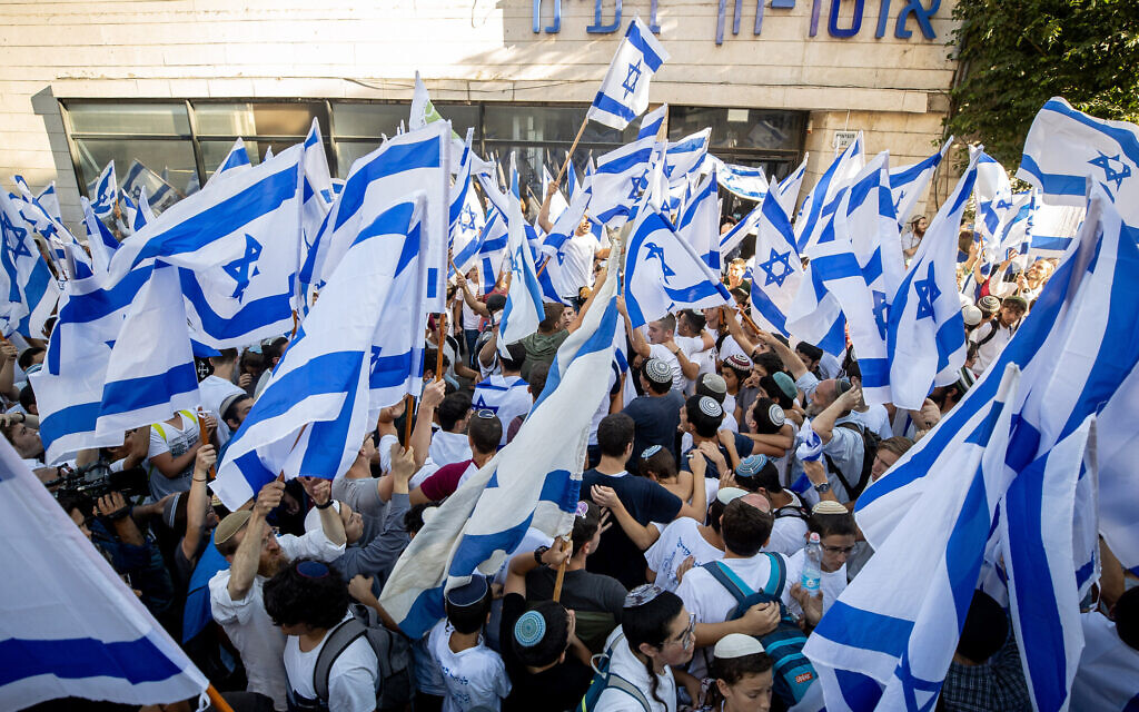 Nationalist Israeli Jews hold Israeli flags and dance near Jerusalem's Old City, June 15, 2021. (Yonatan Sindel/Flash90 )