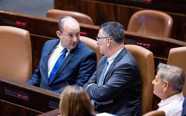 Prime Minister Naftali Bennett with Minister of Justice Gideon Saar during a swearing-in ceremony of new MKs at the Knesset, in Jerusalem, June 16, 2021.(Yonatan Sindel/Flash90) Prime Minister Naftali Bennett with Minister of Justice Gideon Saar during a swearing-in ceremony of new MKs at the Knesset, in Jerusalem, June 16, 2021.(Yonatan Sindel/Flash90)