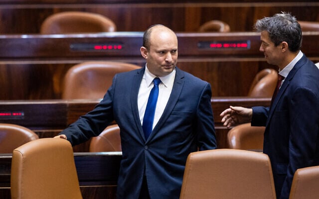 Israeli Prime Minister Naftali Bennett, left, with Minister of Communications Yoaz Hendel during a swearing-in ceremony of new Knesset members in Jerusalem, June 16, 2021. (Yonatan Sindel/Flash90) Israeli Prime Minister Naftali Bennett, left, with Minister of Communications Yoaz Hendel during a swearing-in ceremony of new Knesset members in Jerusalem, June 16, 2021. (Yonatan Sindel/Flash90)