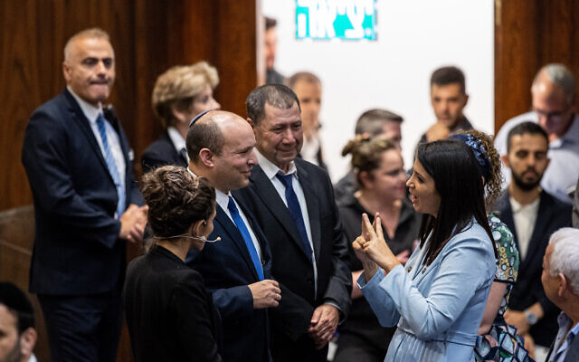 Shirley Pinto, the first deaf Knesset member, with Prime Minister Naftali Bennett and other MKs during a swearing-in ceremony of new Israeli parliament members at the Knesset, June 16, 2021. (Yonatan Sindel/Flash90)