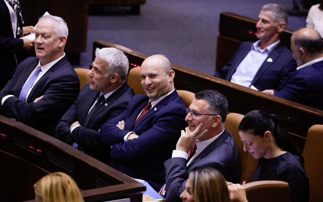 Foreign Minister Yair Lapid (L) with Prime Minister Naftali Bennett (2L) and Justice Minister Gideon Sa'ar (2R) in the assembly hall of the Israeli parliament on June 21, 2021. (Olivier Fitoussi/FLASH90) Foreign Minister Yair Lapid (L) with Prime Minister Naftali Bennett (2L) and Justice Minister Gideon Sa'ar (2R) in the assembly hall of the Israeli parliament on June 21, 2021. (Olivier Fitoussi/FLASH90)