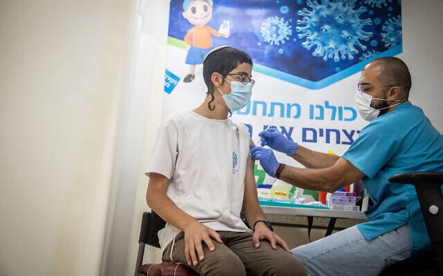 An Israeli receives a COVID-19 vaccine at a Clalit vaccination center in Jerusalem on June 24, 2021. (Yonatan Sindel/Flash90) An Israeli receives a COVID-19 vaccine at a Clalit vaccination center in Jerusalem on June 24, 2021. (Yonatan Sindel/Flash90)