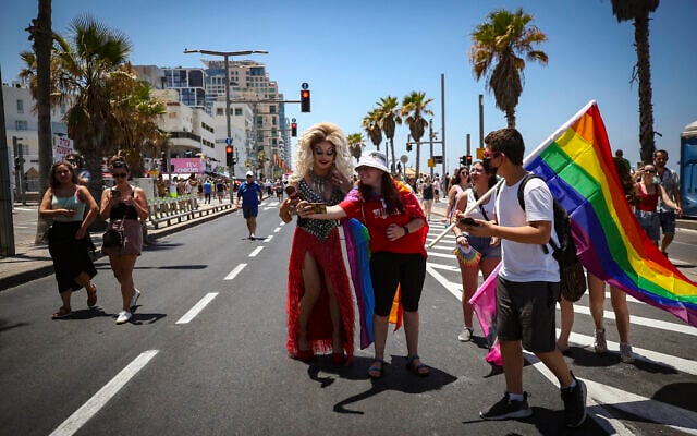 People participate at the annual Gay Pride Parade in Tel Aviv, on June 25, 2021. (Miriam Alster/Flash90) People participate at the annual Gay Pride Parade in Tel Aviv, on June 25, 2021. (Miriam Alster/Flash90)