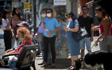 Israelis, some wearing face masks. are seen in Tel Avi, on June 28, 2021. (Miriam Alster/Flash90)