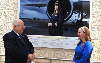 President Ruby Rivlin with Nechama Spiegel Novak, the first ultra-Orthodox woman pilot, whose portrait is portrayed in 'Hamsa Aleinu,' a new exhibit at Ben Gurion Airport (Courtesy GPO)