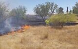 Firefighters try to extinguish a fire caused from an incendiary balloon near the Israeli-Gaza border, southern Israel, on June 15, 2021. (Israel Fire Service)