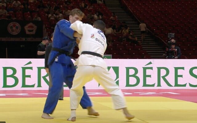 Screen capture from video of Iranian dissident judoka Saeid Mollaei, in white, competing for Mongolia during a bout against Israeli Din Yaacov Gemer during the World Judo Championships in Hungary, June 8, 2021. (YouTube) Screen capture from video of Iranian dissident judoka Saeid Mollaei, in white, competing for Mongolia during a bout against Israeli Din Yaacov Gemer during the World Judo Championships in Hungary, June 8, 2021. (YouTube)