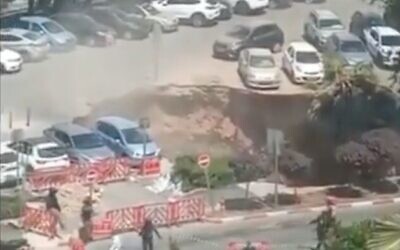 Screen capture from video of a sinkhole that opened in the parking lot of the Shaare Zedek Medical Center in Jerusalem, June 7, 2021. (Twitter)