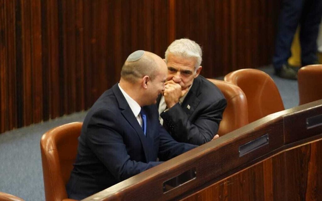 Yesh Atid chairman Yair Lapid (R) and Yamina head Naftali Bennett in the Knesset plenum for the election of Israel's 11th president, June 2, 2021. (Dani Shem Tov/ Knesset)