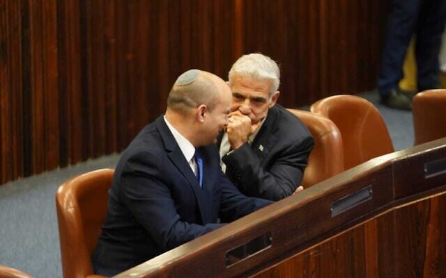 Yesh Atid chairman Yair Lapid (R) and Yamina head Naftali Bennett in the Knesset plenum for the election of Israel's 11th president, June 2, 2021. (Dani Shem Tov/ Knesset) Yesh Atid chairman Yair Lapid (R) and Yamina head Naftali Bennett in the Knesset plenum for the election of Israel's 11th president, June 2, 2021. (Dani Shem Tov/ Knesset)