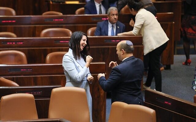 Prime Minister Naftali Bennett and Yamina MK Shirley Pinto communicate via sign language on the Knesset floor on June 16, 2021. (Noam Moskowitz/Knesset)