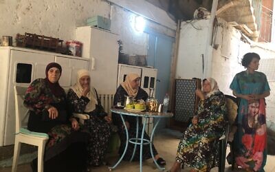 Tina (far right), an Arab resident of Acre, with some of her neighbors. She tried to protect the Jewish-owned gallery where she worked during the recent unrest in the mixed city, and is asking how and why this happened in her city (Jessica Steinberg/Times of Israel)
